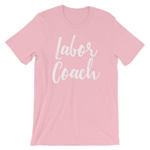 May include: Pink t-shirt with the text "Labor Coach" in white lettering.