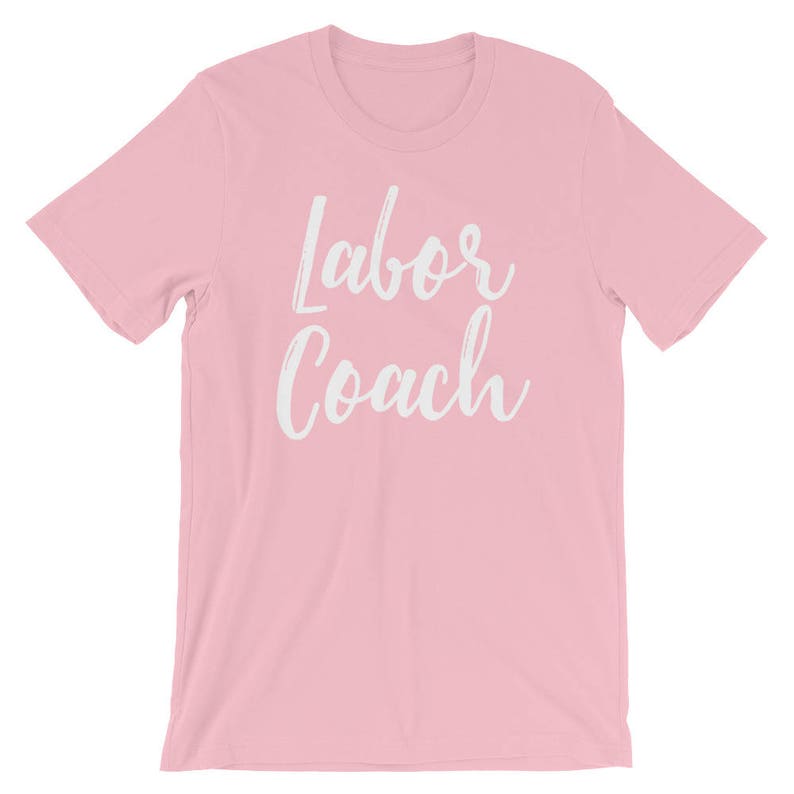 May include: Pink t-shirt with the text "Labor Coach" in white lettering.