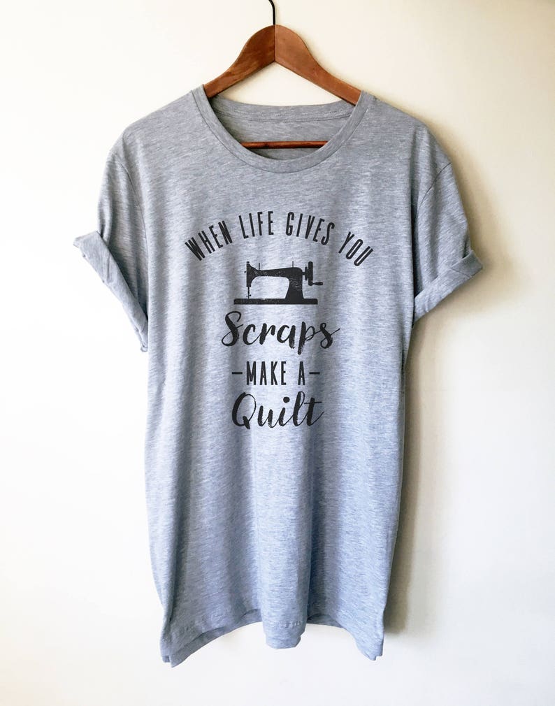 May include: Gray t-shirt with a black graphic of a sewing machine and the text "When life gives you scraps - make a quilt".