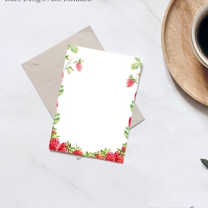 May include: A white card with a red strawberry border. The card has the text "STAG & PEACH Co" at the bottom.