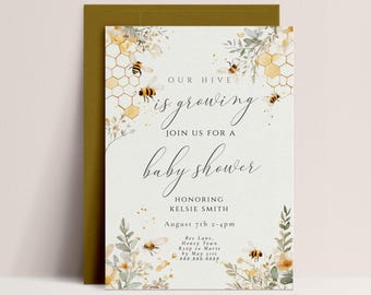 May include: A baby shower invitation with a bee and honeycomb theme. The invitation features a watercolor illustration of bees, flowers, and honeycomb. The text on the invitation reads "Our hive is growing. Join us for a baby shower. Honoring Kelsie Smith. August 7th 2-4pm. Bee Lane, Honey Town. RSVP to Maric by May 11st. 888.888.8888."