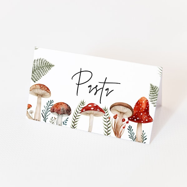 May include: White place card with the name "Pustz" written in black cursive. The bottom of the card is decorated with a row of watercolor mushrooms in shades of red, brown, and white with green leaves.