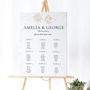 May include: A white wedding seating chart with gold stars and a gold sun and moon design. The chart lists the names of guests assigned to each table number. The text at the top reads "Amelia & George 08.04.2024 please find your seat."