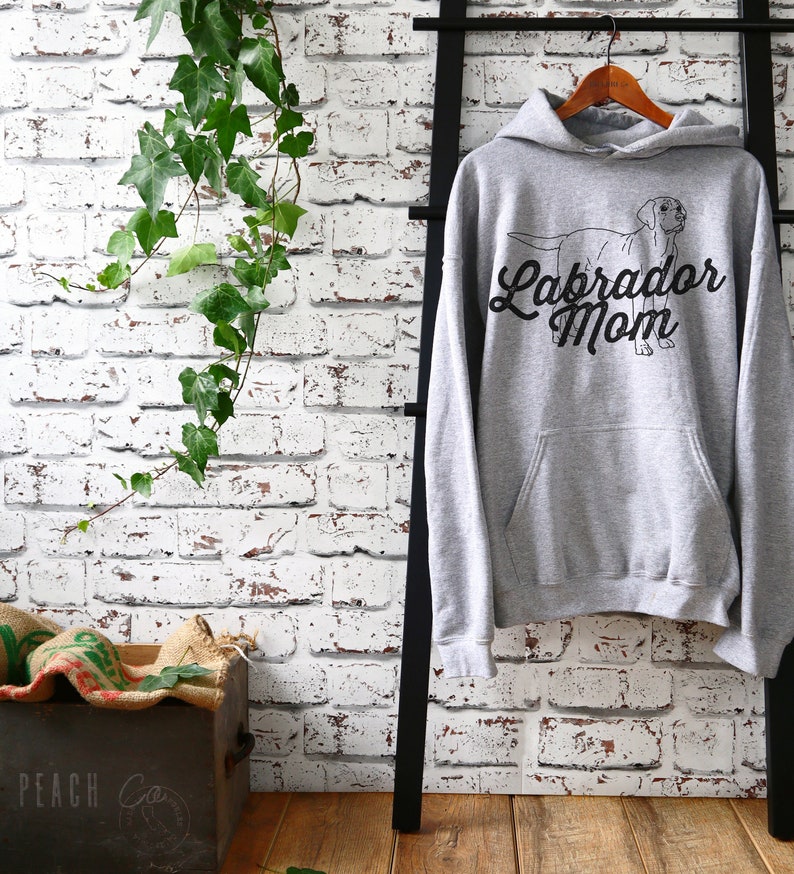 May include: Grey hooded sweatshirt with a black outline of a Labrador Retriever and the text "Labrador Mom" in a black cursive font.