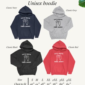May include: Unisex hoodie with a graphic of a human shoulder joint and the text "Let's Rock This Joint". The hoodie is available in four colors: classic navy, classic black, classic grey, and classic red. The size chart shows chest measurements in inches from 40 to 64 inches.