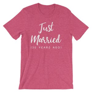 May include: A pink heather t-shirt with the text "Just Married (30 Years Ago)" in white.