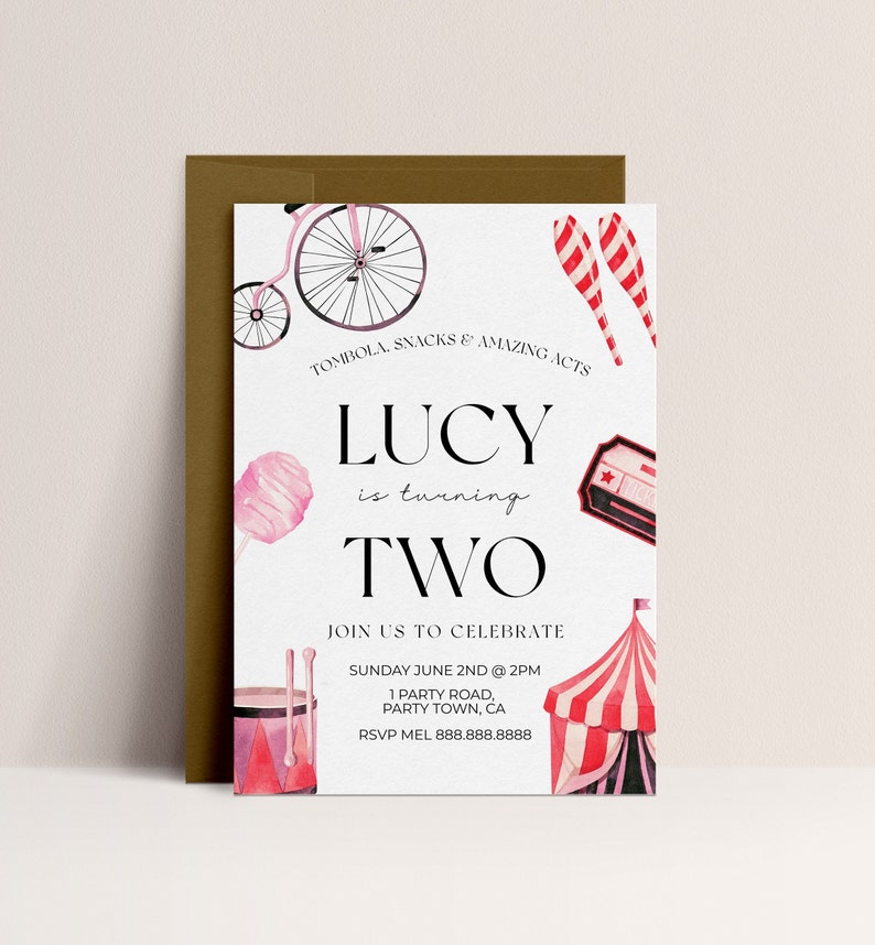 May include: A pink and white circus-themed birthday invitation for a girl turning two. The invitation features a pink and white bicycle, a pink cotton candy, a red and white striped tent, and a red and white striped juggling pin. The text on the invitation reads "Lucy is turning two. Join us to celebrate Sunday June 2nd at 2pm. 1 Party Road, Party Town, CA. RSVP Mel 888.888.8888."