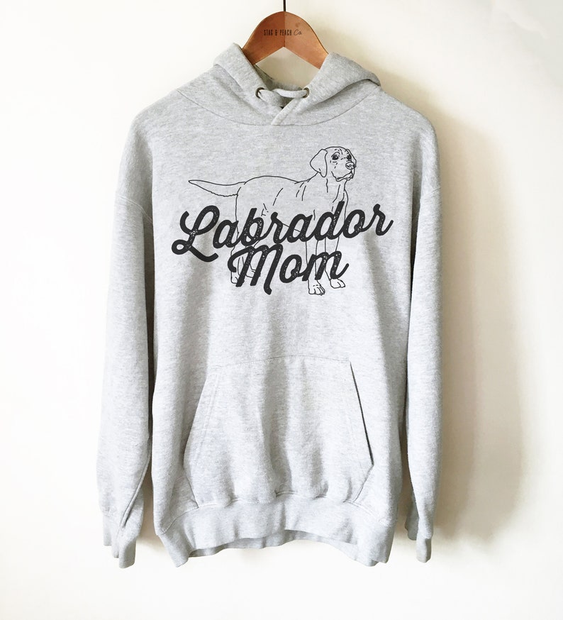 May include: Grey hooded sweatshirt with a black outline of a Labrador Retriever and the text "Labrador Mom" in a black script font.