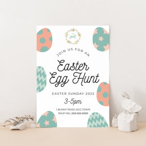 May include: A white invitation card with a pastel pink and blue Easter egg design. The text reads "Join us for an Easter Egg Hunt, Easter Sunday 2022, 3-5pm, 1 Bunny Road, Egg Town, RSVP Mel 888.888.8888".
