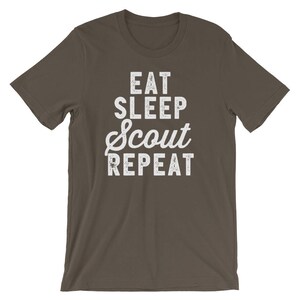 May include: A dark brown t-shirt with white text that reads "Eat Sleep Scout Repeat".