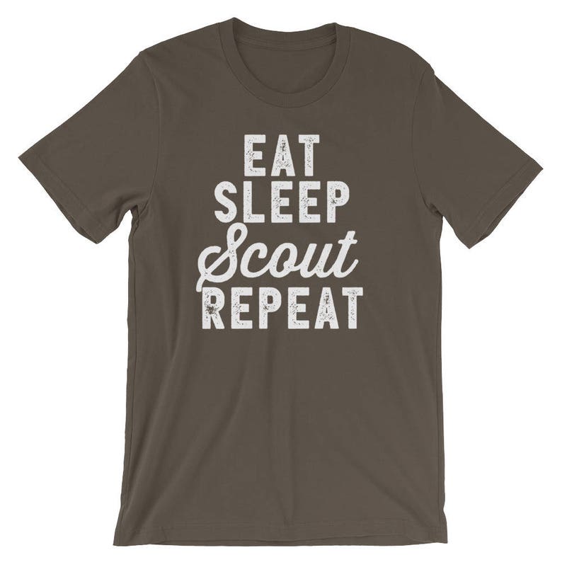 May include: A dark brown t-shirt with white text that reads "Eat Sleep Scout Repeat".