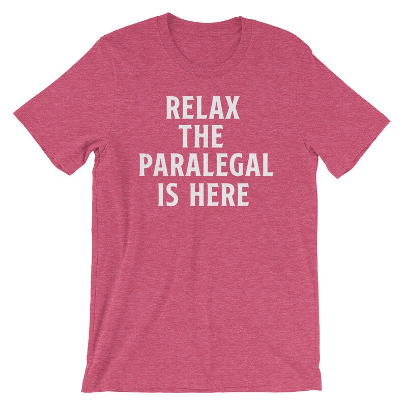 May include: A pink heather t-shirt with the text "Relax the Paralegal is Here" in white.