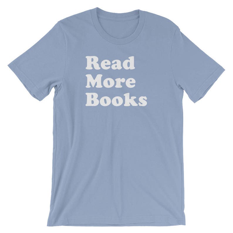 May include: Light blue t-shirt with the text "Read More Books" in white.