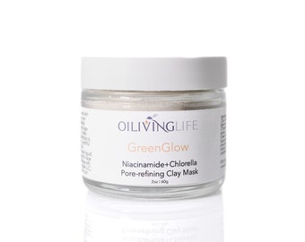 May include: A white jar with a gray lid containing a green clay mask. The jar is labeled "OILIVINGLIFE GreenGlow Niacinamide+Chlorella Pore-refining Clay Mask 2oz 160g".