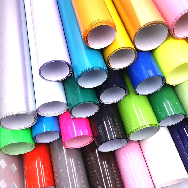 May include: Assortment of colorful vinyl rolls, including silver, white, blue, green, pink, black, yellow, lime green, red, gray, brown, and light pink.