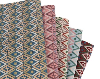 May include: A stack of patterned fabric samples in various colors. The fabrics feature a geometric design with diamond and triangle shapes. Colors include blue, pink, green, and red. The fabrics are likely for upholstery or home decor.