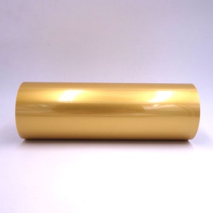 May include: A roll of gold vinyl adhesive film. The film has a shiny, metallic finish.
