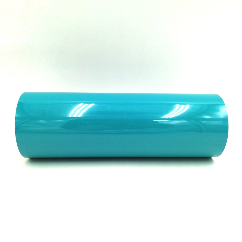 May include: A roll of turquoise vinyl adhesive film. The film is shiny and has a smooth surface.