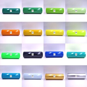 May include: A collection of 16 vinyl rolls in various colors, numbered 17 through 32. The rolls are arranged in four rows of four, with each roll labeled with its corresponding number.