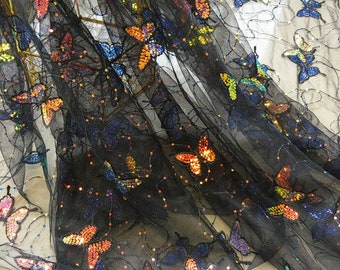 May include: Black sheer fabric with iridescent butterfly sequins. The butterflies are scattered randomly across the fabric.