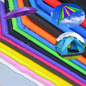 May include: A variety of colorful fabrics, including red, orange, yellow, green, blue, purple, pink, and white. The fabrics are arranged in a stack, with the top fabric being red and the bottom fabric being white. There is a small umbrella, a kite, and a tent in the image.