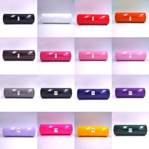 May include: A collection of 16 rolls of vinyl adhesive film in various colors, including black, white, red, orange, brown, pink, gray, navy blue, purple, lavender, hot pink, yellow, and green. The rolls are numbered 1 through 16.