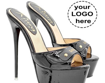 May include: Pair of black patent leather platform heels with a high stiletto heel. The heels have a gold buckle with the word "LOVE" on it. The heels are available in sizes 35 to 44.