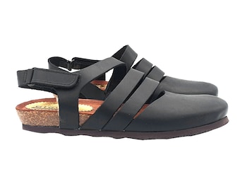 May include: Black leather sandals with a cork platform sole and multiple straps across the foot.