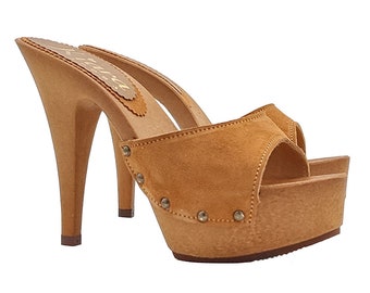 May include: Tan suede and wood platform clog with a high stiletto heel. The clog has a peep toe and is decorated with silver studs.