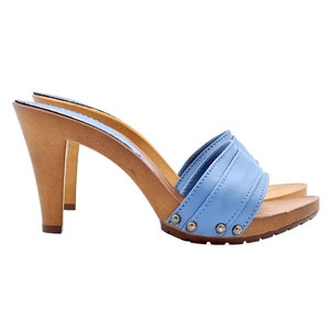 May include: A pair of blue leather heeled clogs with a wooden platform and a studded strap.