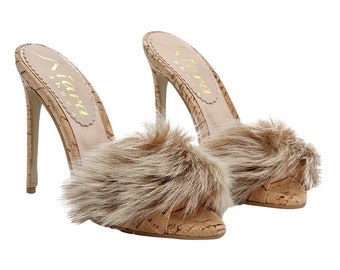 May include: A pair of cork heeled sandals with a fluffy brown fur trim. The sandals are a light brown color and have a pointed toe. The brand name "Tiana Shoes" is printed on the insole.