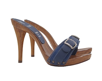 May include: Blue denim and leather heeled clogs with a buckle strap and wooden platform. Made in Italy.