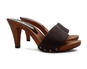 May include: Brown leather heeled clogs with a wooden platform and studded detail.