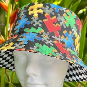Bucket hat reversible all cotton hat. Puzzle Piece to black and white checker.Autism awareness and Puzzle gamer Choose Sizes xs to xl