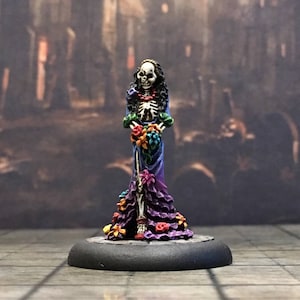Catrina Skeleton 28mm RPG miniature, a Day of the Dead female skeleton figure, with a bouquet. “Sold unpainted”.
