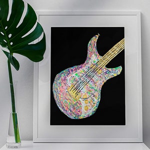 May include: A framed art print featuring a colorful, abstract electric guitar design against a black background. The guitar's body is a mix of vibrant colors, and the strings and neck are gold. The artwork is displayed in a white frame.
