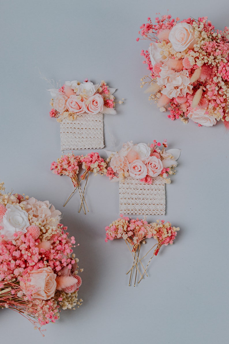 May include: Image of pink and white floral arrangements, including roses and baby's breath, against a light grey backdrop. The image shows several floral hair accessories and bouquets, ideal for weddings or special occasions.