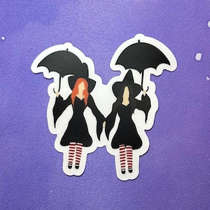 May include: Two witches wearing black dresses and red and white striped stockings are walking side by side, each holding a black umbrella.