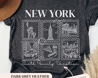 May include: Dark grey heather t-shirt with a white graphic of New York City landmarks, including the Statue of Liberty, the Empire State Building, and the Brooklyn Bridge. The text "NEW YORK" is at the top, with "Smith Family Vacation" below.