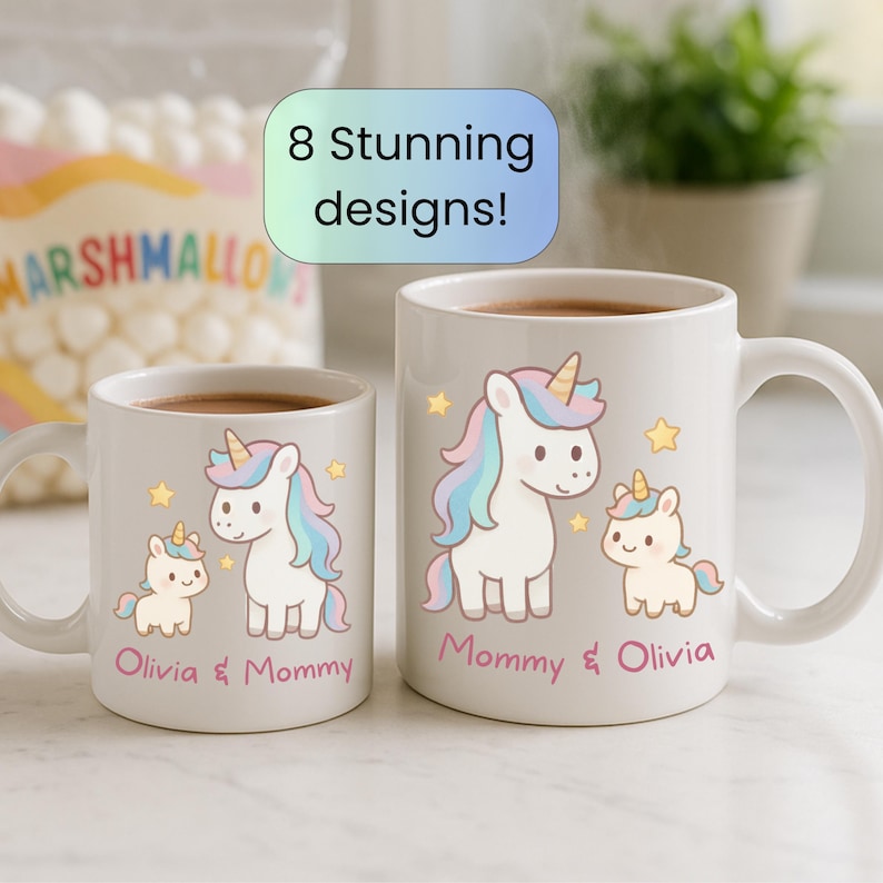 May include: Two white ceramic mugs with a unicorn design. The mugs feature a large unicorn and a smaller unicorn with the text "Mommy & Olivia". The mugs are filled with a dark liquid. The image also includes the text "8 Stunning designs!"