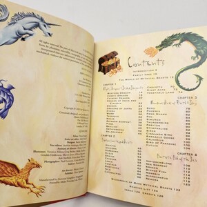 May include: A book open to the contents page, featuring illustrations of a unicorn, a griffin, and a green dragon. The text lists chapters on mythical beasts, including dragons, serpents, and birds, with page numbers for each entry in the book.