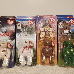 May include: Set of nine Ty Beanie Babies, each in a plastic package with a colorful background. The bears are named Glory, Maple, Britannia, and Erin. Each bear is wearing a different country's flag.