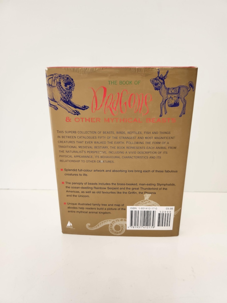 May include: The back cover of a gold-toned book titled The Book of Dragons & Other Mythical Beasts. It features blue line illustrations of a lion and a donkey-like creature, descriptive text, bullet points, and a barcode with ISBN 1-901412-17-0.