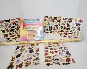May include: A collection of Beanie Babies stickers and related items. The stickers feature various animal designs in different colors. Included are sticker sheets, a checklist, and a newsletter, all with the Beanie Babies logo.