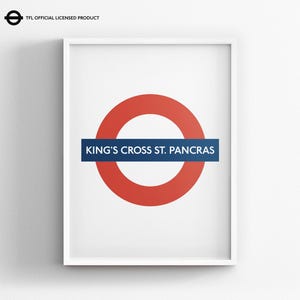 May include: A framed wall art print featuring the iconic London Underground roundel logo in red and blue with the text KING'S CROSS ST. PANCRAS in white. The top left corner includes the TFL OFFICIAL LICENSED PRODUCT logo and text.