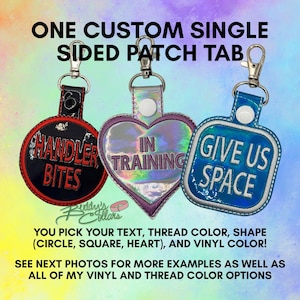 May include: Three custom single-sided patch tabs with metal lobster clasps. One black circle with red text reading HANDLER BITES, one iridescent heart with purple text reading IN TRAINING, and one blue square with white text reading GIVE US SPACE.