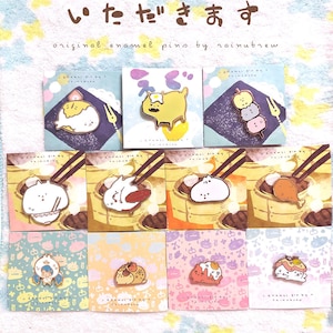 May include: A set of 10 enamel pins featuring cute cartoon characters. The pins are on a white background with a light blue and yellow pattern. The pins are all different colors and feature different characters, including a cat, a dog, a bunny, and a bear. The pins are all about 1 inch in size. The text on the cards reads "original enamel pins by rainubrew".