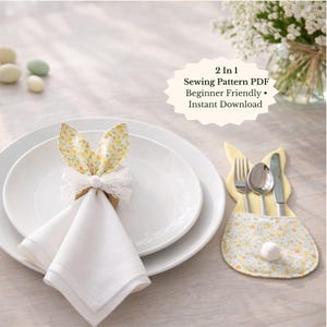 May include: A white linen napkin is held by a bunny ear napkin ring with a white lace bow. A bunny-shaped utensil holder with a floral pattern holds a fork, spoon, and knife. The image includes the text: "2 in 1 Sewing Pattern PDF Beginner Friendly • Instant Download."