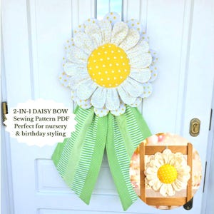 May include: A large, handmade daisy bow with white petals dotted with yellow circles and a yellow center with white hearts. Green and white striped and polka-dot ribbons hang below. Text reads "2-IN-1 DAISY BOW Sewing Pattern PDF".