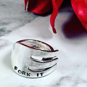 May include: Silver ring made from a fork with the words "Fork It" engraved on the side.